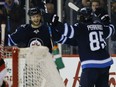 Joel Armia, left, and Mathieu Perreault of the Jets celebrate Perreault's goal against the New Jersey Devils during second period NHL action in Winnipeg on Saturday.
