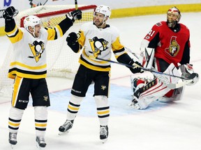 Patric Hornqvist, left, celebrates his goal with Penguins teammate Riley Sheahan against Senators netminder Craig Anderson during the second period of their game in Ottawa on Thursday night.