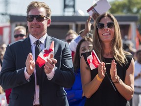 Former Ottawa Senators NHL player Daniel Alfredsson and his wife Bibi clap during a citizenship ceremony for the World Cup of Hockey 2016 Legacy Project in 2016.