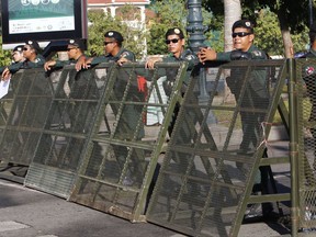 Riot police stand guard at a blocked street outside the supreme court in Phnom Penh, Cambodia, Thursday, Nov. 16, 2017. Cambodia's embattled opposition braced for a court ruling due Thursday that is widely expected to see the party dissolved in the latest move by authoritarian Prime Minister Hun Sen to remove threats to his power ahead of elections next year. (AP Photo/Heng Sinith)