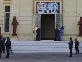 Security personnel guard the Supreme Court during its hearing in the crucial case to dissolve the country's main opposition Cambodia National Rescue Party in Phnom Penh, Cambodia, Thursday, Nov. 16, 2017. Cambodia's Supreme Court ordered the main opposition party to be dissolved on Thursday, dealing a crushing blow to democratic aspirations in the increasingly oppressive Southeast Asian state. The decision clears the way for the nation's authoritarian leader to remain in power for years to come. (AP Photo/Heng Sinith)