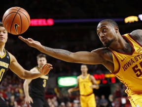 Iowa State forward Jeff Beverly (55) fights for a loose ball with Milwaukee forward Brett Prahl (50) during the first half of an NCAA college basketball game, Monday, Nov. 13, 2017, in Ames, Iowa. (AP Photo/Charlie Neibergall)