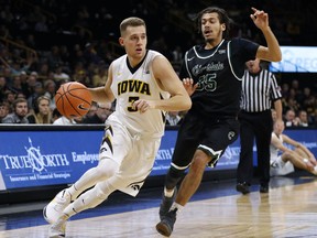 Iowa guard Jordan Bohannon drives past Chicago State guard Rob Shaw, right, during the first half of an NCAA college basketball game, Friday, Nov. 10, 2017, in Iowa City, Iowa. (AP Photo/Charlie Neibergall)