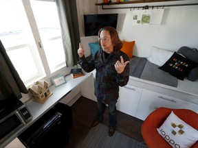 In this Wednesday, Oct. 11, 2017, photo, Joe Stevens stands in one of the tiny homes his group has built, in Des Moines, Iowa. Tiny homes have been promoted as the solution to all kinds of housing needs, shelter for the homeless, an affordable option for expensive big cities and simplicity for people who want to declutter their lives. But the same popularity that inspired at least six national TV shows about the homes often fails to translate into acceptance when developers try to build them next door. (AP Photo/Charlie Neibergall)