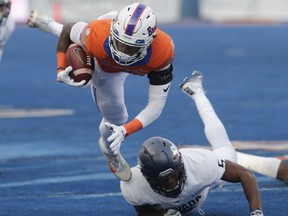 Boise State wide receiver Cedrick Wilson is upended by Nevada defensive back Dameon Baber during the first half of an NCAA college football game in Boise, Idaho, Saturday, Nov. 4, 2017. (AP Photo/Otto Kitsinger)