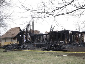 Police tape cordoned off a badly damaged home along the 200 block of North Miami Drive, Tuesday, Nov. 21, 2017, in Dixon, Ill., where six people died in an overnight fire, according to the local sheriff. (Stacey Wescott/Chicago Tribune via AP)