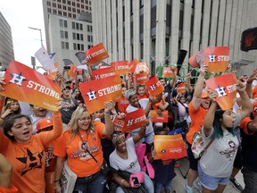 Houston Astros fans celebrate before a parade honoring the World Series baseball champions, Friday, Nov. 3, 2017, in Houston. (AP Photo/David J. Phillip)