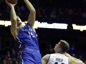 Creighton forward Martin Krampelj, left, shoots against Northwestern forward Gavin Skelly during the first half of an NCAA college basketball game, Wednesday, Nov. 15, 2017, in Rosemont, Ill. (AP Photo/Nam Y. Huh)