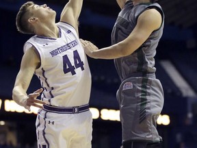 Northwestern forward Gavin Skelly, left, blocks a shot by Loyola (Md.) forward Ian Langendoefer during the first half of an NCAA college basketball game Friday, Nov. 10, 2017, in Rosemont, Ill. (AP Photo/Nam Y. Huh)