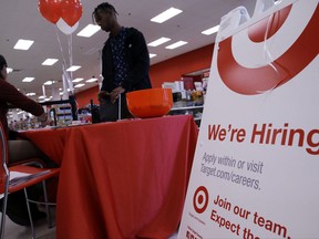 In this Sunday, Oct. 15, 2017, photo, a job seeker, standing, talks with a Target human resources representative at a Target store in Chicago. On Wednesday, Nov. 1, 2017, payroll processor ADP reports how many jobs private employers added in October. (AP Photo/Nam Y. Huh)