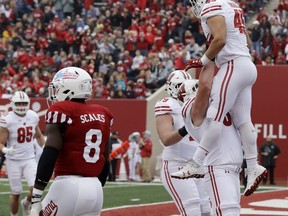 Wisconsin's Alec Ingold (45) celebrates with Jon Dietzen after Ingold scored on an 18-yard touchdown reception during the first half of an NCAA college football game against Indiana, Nov. 4, 2017, in Bloomington, Ind. (AP Photo/Darron Cummings)