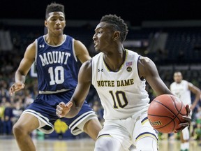 Notre Dame's T.J. Gibbs, right, turns downcourt as he is pressured by Mount St. Mary's Donald Carey during the first half of an NCAA college basketball game Monday, Nov. 13, 2017, in South Bend, Ind. (AP Photo/Robert Franklin)