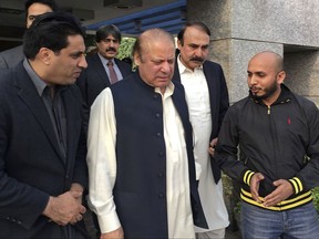 This photo released by the Pakistan Muslim League, the political party of ousted Pakistani Prime Minister Nawaz Sharif, shows Sharif, center, as he arrives to Punjab house, a PML party residence, in Islamabad, Pakistan. Thursday, Nov. 2, 2017. Sharif has returned home from London to face trial in corruption cases. (Pakistan Muslim League, via AP)