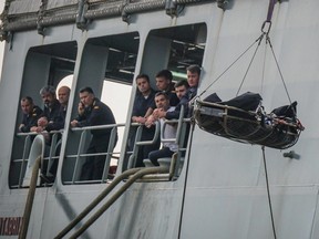 Rescuers recover a dead body from the Spanish ship 'Cantabria' in the harbour of Salerno, Italy, Sunday, Nov. 5 2017. UNHCR spokesperson Marco Rotunno said that the 26 dead were involved in a shipwreck two days ago off Libya.