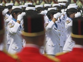 In this Aug. 17, 2012 photo, female members of Indonesian Navy salute during a ceremony commemorating the Independence Day at Merdeka Palace in Jakarta, Indonesia. Indonesia's military and police continue to perform abusive virginity tests on female recruits three years after the World Health Organization declared they had no scientific validity, an international human rights group said Wednesday, Nov. 22, 2017. (AP Photo/Dita Alangkara)