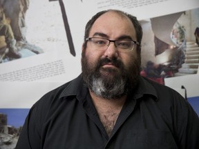 In this photo taken Tuesday, Nov. 21, 2017. Yehuda Shaul, co-founder and Foreign Relations Director of "Breaking the Silence" poses for photo after media briefing, in Tel Aviv, Israel. Spokesperson of the group, Dean Issacharoff, a former Israeli combat officer turned whistleblower, has found himself in the fight of his lifetime, leading a campaign against Israel's occupation of the West Bank and drawing relentless criticism from the country's leaders who have labeled him a traitor. For Issacharoff, the battle is even more personal: his father is Israel's ambassador to Germany. (AP Photo/Oded Balilty)