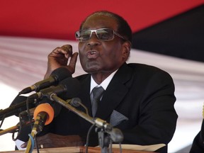 FILE -- In this Wednesday, Nov. 1, 2017 file photo, Zimbabwean President Robert Muagbe addresses mourners at the Heroes Acre in Harare.  Lawyers and a U.S. Embassy official have said Friday Nov. 3, 2017, Zimbabwe police have arrested a United States citizen, named as Martha O'Donovan, for allegedly insulting President Robert Mugabe on Twitter. (AP Photo/Tsvangirayi Mukwazhi, File)