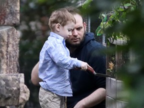Freed Canadian hostage Joshua Boyle watches as one of his children plays outside the Boyle's family home in Smiths Falls, Ont., on Oct. 14, 2017.