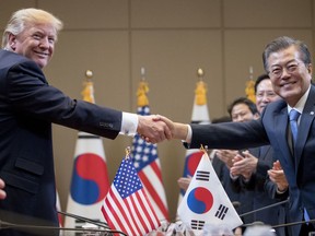 President Donald Trump, left,  and South Korean President Moon Jae-in shake hands during a bilateral meeting at the Blue House in Seoul, South Korea, Tuesday, Nov. 7, 2017. Trump is on a five country trip through Asia traveling to Japan, South Korea, China, Vietnam and the Philippines. (AP Photo/Andrew Harnik)