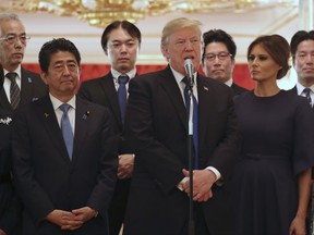 CORRECTS TO JAPANESE ABDUCTED BY NORTH KOREA- President Donald Trump, center, speaks as Trump and first lady Melania Trump, right,  meet with the families of Japanese abducted by North Korea at the Akasaka Palace, Monday, Nov. 6, 2017, in Tokyo. Trump is on a five country trip through Asia traveling to Japan, South Korea, China, Vietnam and the Philippines.  Japanese Prime Minister Shinzo Abe, is at center left while his wife Akie at far left.  At center rear is Koichiro Iizuka, whose mother Yaeko Taguchi was abducted by North Korean agents in 1978. (AP Photo/Andrew Harnik)