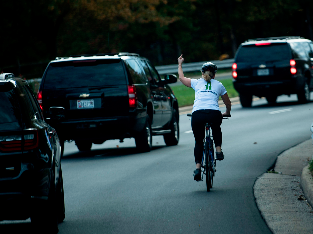 Woman impulsively flips off Donald Trump while riding her bike and ends