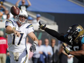 Los Angeles Chargers quarterback Philip Rivers (17) throws a pass as he is pressured by Jacksonville Jaguars defensive end Dante Fowler Jr., during the first half of an NFL football game, Sunday, Nov. 12, 2017, in Jacksonville, Fla. (AP Photo/Stephen B. Morton)