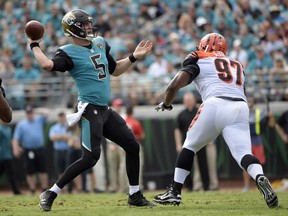 Jacksonville Jaguars quarterback Blake Bortles (5) throws a pass as he is rushed by Cincinnati Bengals defensive tackle Geno Atkins (97) during the first half of an NFL football game, Sunday, Nov. 5, 2017, in Jacksonville, Fla. (AP Photo/Phelan M. Ebenhack)