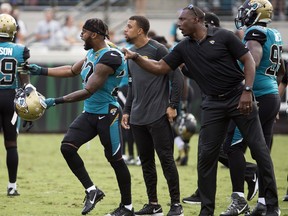 Jacksonville Jaguars cornerback Aaron Colvin is held back as he shouts at Cincinnati Bengals players during an altercation in the first half of an NFL football game, Sunday, Nov. 5, 2017, in Jacksonville, Fla. (AP Photo/Stephen B. Morton)