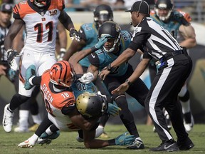 Cincinnati Bengals wide receiver A.J. Green (18) takes down Jacksonville Jaguars cornerback Jalen Ramsey (20) during a fight in the first half of an NFL football game Sunday, Nov. 5, 2017, in Jacksonville, Fla. (AP Photo/Phelan M. Ebenhack)