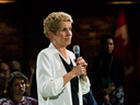 Premier Kathleen Wynne addresses questions from the public during a town hall meeting in Toronto on Monday, Nov. 20, 2017.