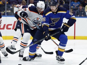St. Louis Blues' Colton Parayko (55) and Edmonton Oilers' Oscar Klefbom, of Sweden, (77) chase after a loose puck during the second period of an NHL hockey game Tuesday, Nov. 21, 2017, in St. Louis.
