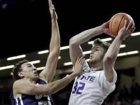 Kansas State's Dean Wade (32) shoots under pressure from Oral Roberts's Javan White (25) during the first half of an NCAA college basketball game Wednesday, Nov. 29, 2017, in Manhattan, Kan. (AP Photo/Charlie Riedel)