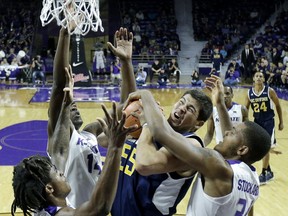 Kansas State's Cartier Diarra, left, Makol Mawien (14) and Levi Stockard III, right, pressure UC Irvine's Brad Greene (55) during the first half of an NCAA college basketball game Friday, Nov. 17, 2017, in Manhattan, Kan. (AP Photo/Charlie Riedel)