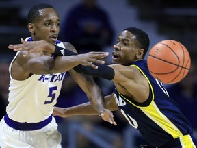 Kansas State guard Barry Brown (5) passes to a teammate while covered by Northern Arizona guard Torry Johnson (0) during the first half of an NCAA college basketball game in Manhattan, Kan., Monday, Nov. 20, 2017. (AP Photo/Orlin Wagner)