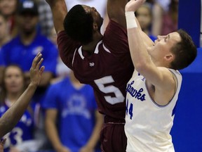 Texas Southern center Trayvon Reed (5) shoots over Kansas forward Mitch Lightfoot (44) during the first half of an NCAA college basketball game in Lawrence, Kan., Tuesday, Nov. 21, 2017. (AP Photo/Orlin Wagner)