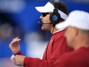 Oklahoma head coach Lincoln Riley signals a play during the first half of an NCAA college football game against Kansas in Lawrence, Kan., Saturday, Nov. 18, 2017. (AP Photo/Orlin Wagner)