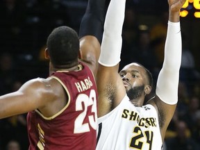 Wichita State's Shaquille Morris (24) hits a 3-pointer over College of Charleston's Nick Harris (23) during the first half of an NCAA college basketball game Monday, Nov. 13, 2017, in Wichita, Kan. (Fernando Salazar/The Wichita Eagle via AP)