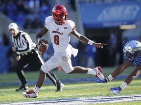 Louisville quarterback Lamar Jackson scrambles past Kentucky defensive tackle Kordell Looney during the second half of an NCAA college football game, Saturday, Nov. 25, 2017, in Lexington, Ky. Louisville won the game 44-17. (AP Photo/David Stephenson)