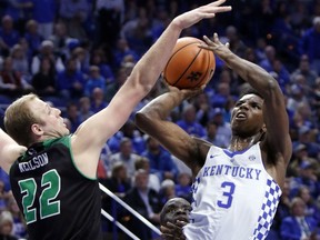 Kentucky's Hamidou Diallo (3) takes an off balance shot while defended by Utah Valley's Isaac Neilson (22) during the first half of an NCAA college basketball game, Friday, Nov. 10, 2017, in Lexington, Ky. (AP Photo/James Crisp)