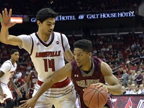 Southern Illinois guard Aaron Cook (10) attempts to drive past the defense of Louisville forward Anas Mahmoud (14) during the first half of an NCAA college basketball game, Tuesday, Nov. 21, 2017, in Louisville, Ky. (AP Photo/Timothy D. Easley)