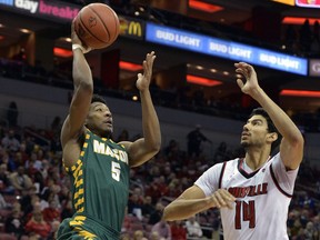 George Mason guard Jaire Grayer (5) shoots over the defense of Louisville forward Anas Mahmoud (14) during the first half of an NCAA college basketball game, Sunday, Nov. 12, 2017, in Louisville, Ky. (AP Photo/Timothy D. Easley)