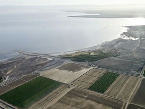 FILE - This May 1, 2015 file photo shows the exposed lake bed of the Salton Sea drying out near Niland, Calif. California regulators Tuesday, Nov. 7, 2017, approved a plan to spend nearly $400 million over 10 years to slow the shrinking of the state's largest lake, a major resting place for migratory birds and a buffer against swirling dust in farming towns. (AP Photo/Gregory Bull, File)