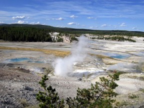 FILE - This September, 2009 file photo shows the Norris Geyser Basin in Yellowstone National Park, Wyo. A legislative panel is considering a new tax to help fund Wyoming's tourism promotion efforts. The Legislature's Joint Revenue Committee on Tuesday, Nov. 7, 2017 is drafting a bill that would impose a 1 percent tax at hotels, restaurants, bars and other leisure and hospitality establishments around the state. (AP Photo/Beth Harpaz, File)
