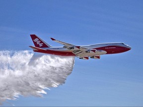 FILE - This May 5, 2016, file photo provided by Global Supertanker Services shows a Boeing 747 making a demonstration water drop at Colorado Springs Airport in Colorado Springs, Colo. The giant passenger jet converted to fight wildfires but grounded by U.S. officials during much of this year's fire season could be aloft much more next year. The U.S. Government Accountability Office on Thursday, Nov. 9, 2017, sided with Global SuperTanker Services in its protest against the U.S. Forest Service. The Colorado-based company challenged the Forest Service's 5,000-gallon (19,000-liter) limit on air tankers that kept the 19,000-gallon (72,000-liter) Boeing 747-400 idle until late August. After that it flew only in California. (Hiroshi Ando/Global Super Tanker Services LLC via AP, File)
