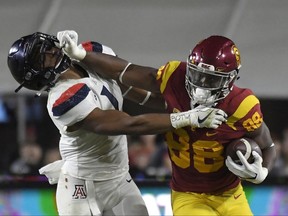 Southern California tight end Daniel Imatorbhebhe, right, stiff-arms Arizona linebacker Tony Fields II during the first half of an NCAA college football game, Saturday, Nov. 4, 2017, in Los Angeles. (AP Photo/Mark J. Terrill)