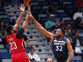New Orleans Pelicans forward Anthony Davis (23) shoots against Minnesota Timberwolves center Karl-Anthony Towns (32) during the first half of an NBA basketball game in New Orleans, Wednesday, Nov. 29, 2017. (AP Photo/Gerald Herbert)