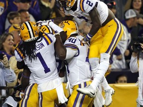 LSU players celebrate an interception during the first half of an NCAA college football game against Texas A&M in Baton Rouge, La., Saturday, Nov. 25, 2017. (AP Photo/Gerald Herbert)