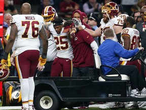 Washington Redskins running back Chris Thompson (25) is helped onto a cart after being injured in the second half of an NFL football game against the New Orleans Saints in New Orleans, Sunday, Nov. 19, 2017. (AP Photo/Butch Dill)
