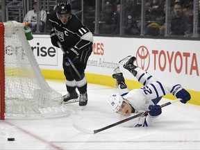 Toronto Maple Leafs center William Nylander, right, falls as he passes the puck while under pressure from Los Angeles Kings center Anze Kopitar, of Slovenia, during the first period of an NHL hockey game, Thursday, Nov. 2, 2017, in Los Angeles. (AP Photo/Mark J. Terrill)