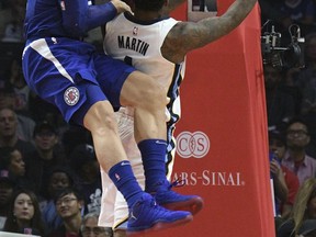 Los Angeles Clippers forward Blake Griffin, left, defends against a shot by Memphis Grizzlies forward Jarell Martin during the first half of an NBA basketball game, Saturday, Nov. 4, 2017, in Los Angeles. (AP Photo/Michael Owen Baker)